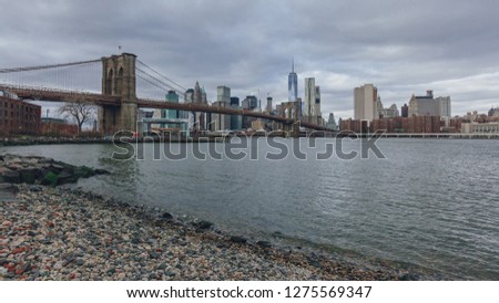Manhattan skyline viewed from Brooklyn with Brooklyn bridge over East River, in New York City, USA