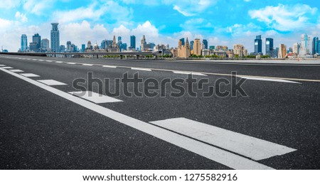 Empty asphalt road along modern commercial buildings in China,s 