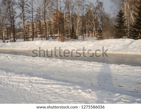 Winter landscape of the open city Park with ice skating track
