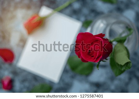 Valentine's Day is approaching, let's celebrate! The blank postcard and red roses place on marble background, just for special sweet and love occasion. Lovers,  couple, romance, romantic, concept.