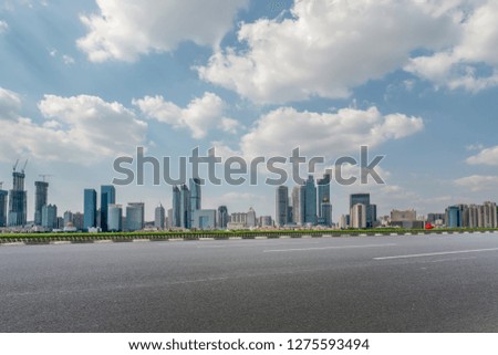 Empty asphalt road along modern commercial buildings in China,s 