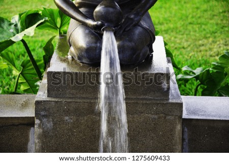 Waterfall statue with green background