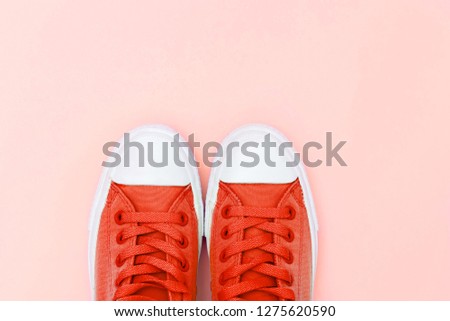 Sneakers living coral color. Flat lay