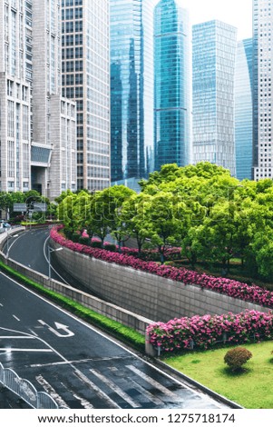 Spacious asphalt pavement and modern commercial buildings in Shanghai.
