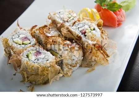 Picture of tasty looking sushi plate .