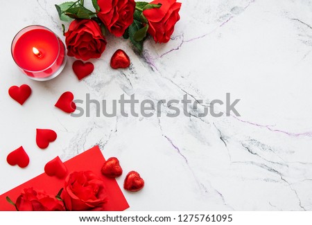 Valentines day romantic background - red roses, candle and hearts Royalty-Free Stock Photo #1275761095
