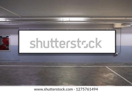 indoor car parking and empty white billboard .Blank space for text and images.