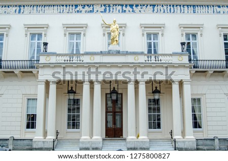Facade of the historic Athenaeum Club in the St James's district of central London.  Famous for attracting members from science, the club building is adorned with a frieze inspired by the Parthenon Royalty-Free Stock Photo #1275800827