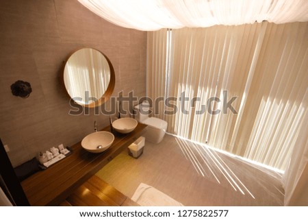 Luxurious bathroom with white curtains with sunlight.