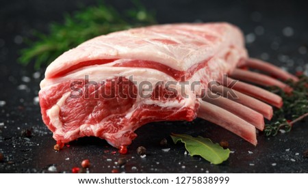 raw fresh rack of lamb with green herbs. Royalty-Free Stock Photo #1275838999