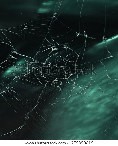 The texture of broken glass and dust on the green and black background  