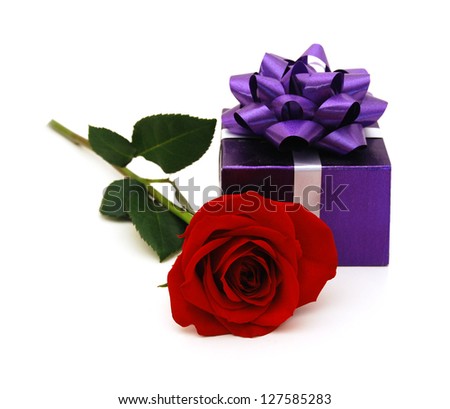 purple gift box with gift ribbon and rose flower isolated on white