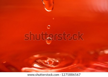 Photo of a drop of water on a red background
