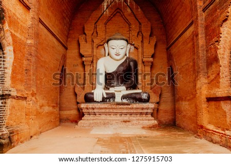 buddha statue in red colour ruins quiet temple on Myanmar