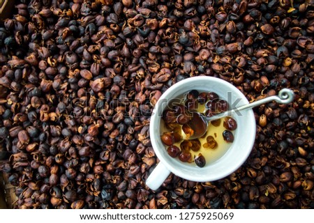 Coffee cherry tea made from the dried skins of dried berries of the coffee plant Cascara in a white cup, Selective focus. Royalty-Free Stock Photo #1275925069