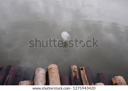 Bubbles floating on a lake in front of bamboos