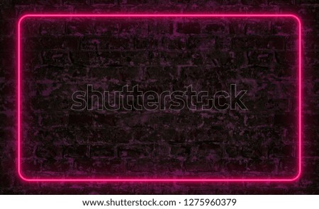Pink neon frame on dark brick wall with copy space