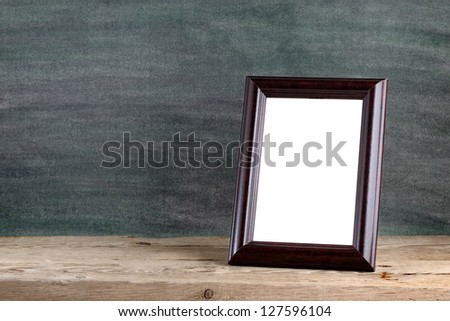 Old photo frame on wooden table