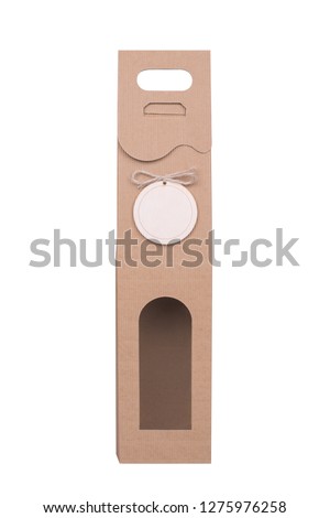 Empty cardboard pack for wine bottle isolated on white background decorated with blank wooden label. Clipping path included.