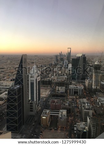 high angle view overlooking riyadh city cityscape and skyline at dusk in the afyernoon with kingdom tower mamlaka Royalty-Free Stock Photo #1275999430