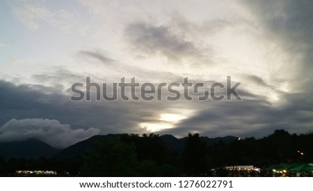 sky and dark cloud, silhouette trees and mountain, sunset background