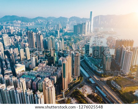 Top view aerial photo from flying drone of a developed Hong Kong city with modern skyscrapers with contemporary design. China town with business and financial centers and road with cars - Image