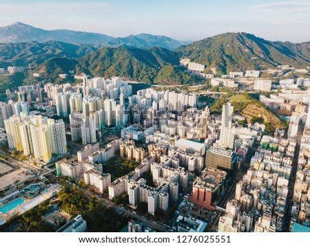 Top view aerial photo from flying drone of a developed Hong Kong city with modern skyscrapers with contemporary design. China town with business and financial centers and road with cars - Image