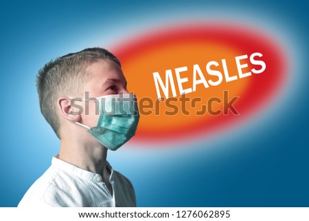 Little boy in a medical mask on a bright background with inscription MEASLES.