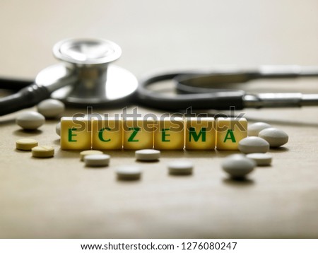 letter block form the word ECZEMA with stethoscope. Medical concept