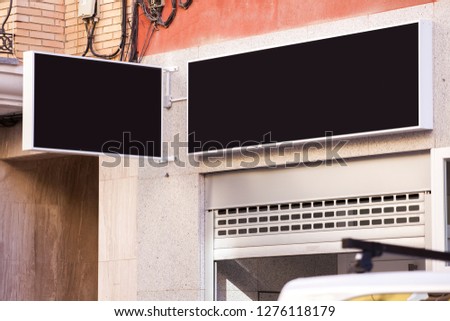 A sign above the store. Promotional poster. Billboard Street advertising. Shop window. Place for text. Mock up.