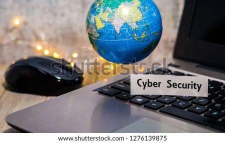 Cyber Security still life business technology concept with laptop, stock chart, shallow DOF