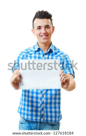 Satisfied young handsome man holding and showing blank card ready for your text
