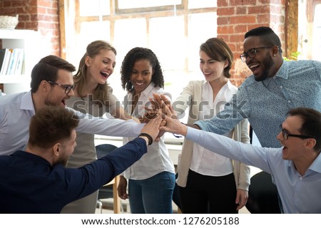 Happy diverse colleagues team people give high five together celebrate great teamwork result motivated by business success victory loyalty unity concept, good corporate relations and teambuilding Royalty-Free Stock Photo #1276205188