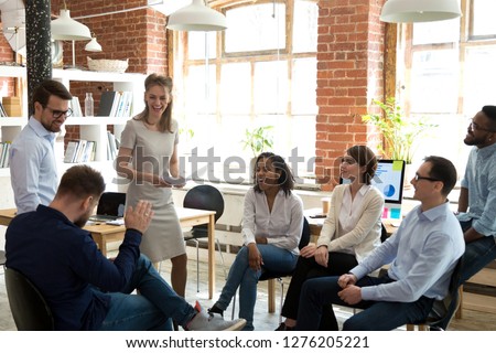 Happy friendly business team having fun at corporate training, funny teambuilding activity, diverse employees group laughing at briefing, colleagues joking together at meeting, staff good relations Royalty-Free Stock Photo #1276205221