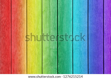 Vertical wooden planks painted as rainbow with ribbed surface as texture, background (concept, gradient)
