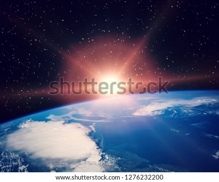 Sunflare and the earth from space. The elements of this image furnished by NASA.
