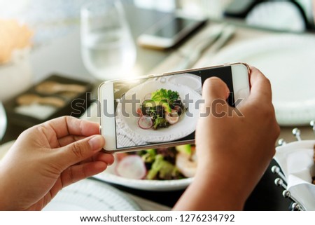 Blur background of delicious handmade organic natural avocado green salad with photography smartphone mobile take top view photo post on friend social media technology share healthy lifestyle meal