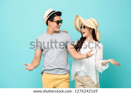 Happy Asian couple in summer beach casual clothes studio shot isolated on light blue background