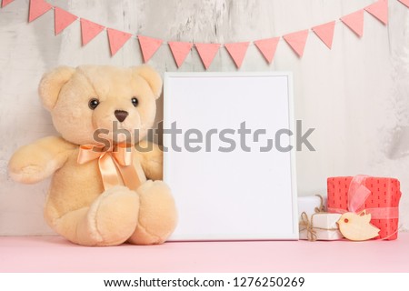 Baby toys and frame on light wall background, for design. Baby shower