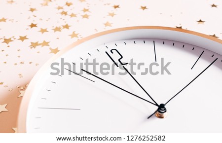 New year clock and golden stars on a light pastel background. Christmas, New Year, winter concept.  