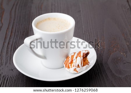 Tasty sweets and coffee cup on wooden background