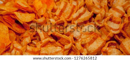 background corrugated golden chips with texture. A variety of potato chips background. Background corrugated golden chips with texture.