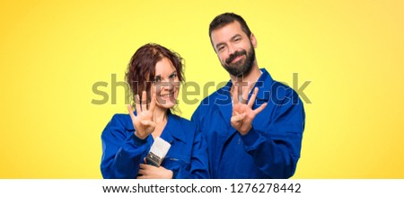 Painters happy and counting four with fingers on colorful background