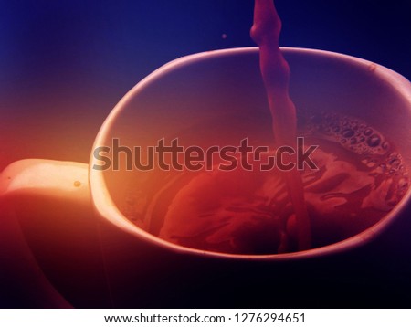Coffee mug. Delicious coffee. Nice coffee. Lots of spray. A lot of drops. Droplets. Bright background. Colorful background. Beautiful background.