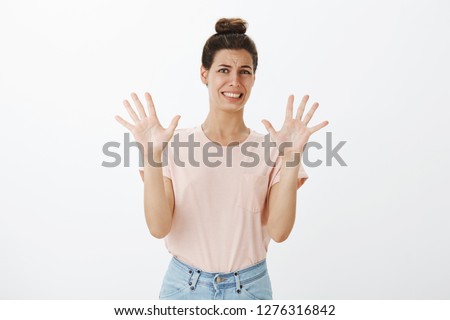 Yikes it is disgusting. Intense awkward and displeased woman about to puke from aversion and dislike waving raised palms in rejection and rejection making tight smile and frowning from displeasure Royalty-Free Stock Photo #1276316842