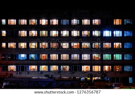 Windows at night. House building lights background Royalty-Free Stock Photo #1276356787