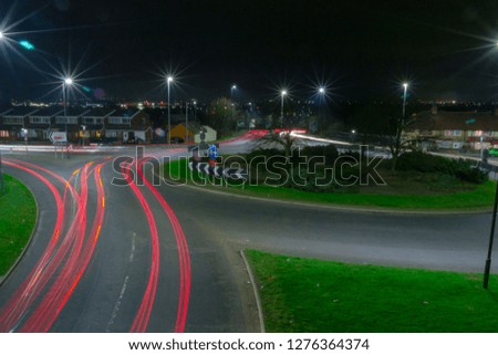 Light painting with car lights at night time round a roundabout 