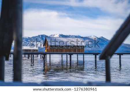 Beautiful cabin along the lake Tahoe water in California nearby the snow capped mountains during a road trip stop driving through San Francisco near Truckee