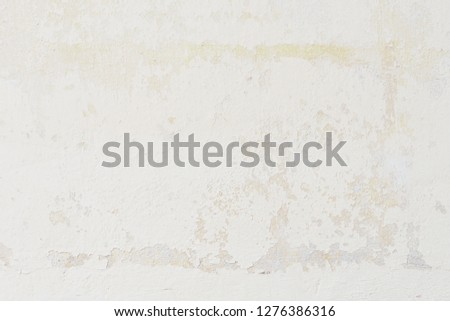 Stains and cracks on the concrete wall for rustic and grunge background in bright vintage tone