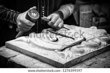 Carving stone in a traditional way, craftsmanship detail, shaping the stone Royalty-Free Stock Photo #1276399597